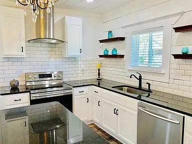 602 South Chestnut Street McKinney, TX 75069 - Photo 8 of 24 a kitchen with stainless steel appliances a sink stove and cabinets