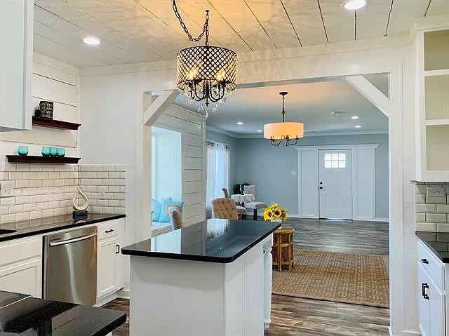 602 South Chestnut Street McKinney, TX 75069 - Photo 10 of 24 a kitchen with stainless steel appliances granite countertop a sink and a stove