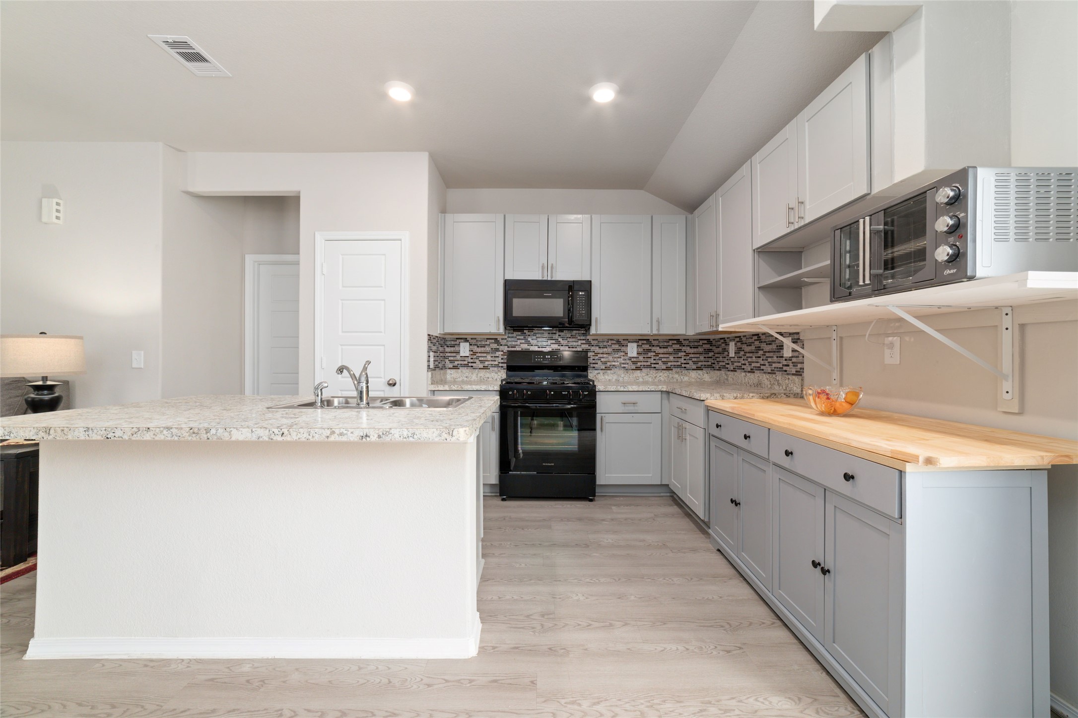 14232 Shasta Ridge Drive Conroe, TX 77303 - Photo 12 of 26 Open kitchen layout with abundant storage and natural light, designed to flow effortlessly into the dining and living areas.