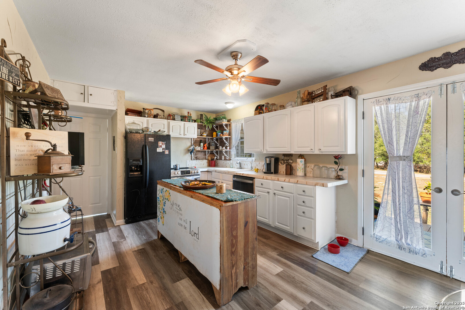 1843 Rhinestone Canyon Lake, TX 78133 - Photo 14 of 39 a kitchen with stainless steel appliances a stove a refrigerator cabinets and wooden floor