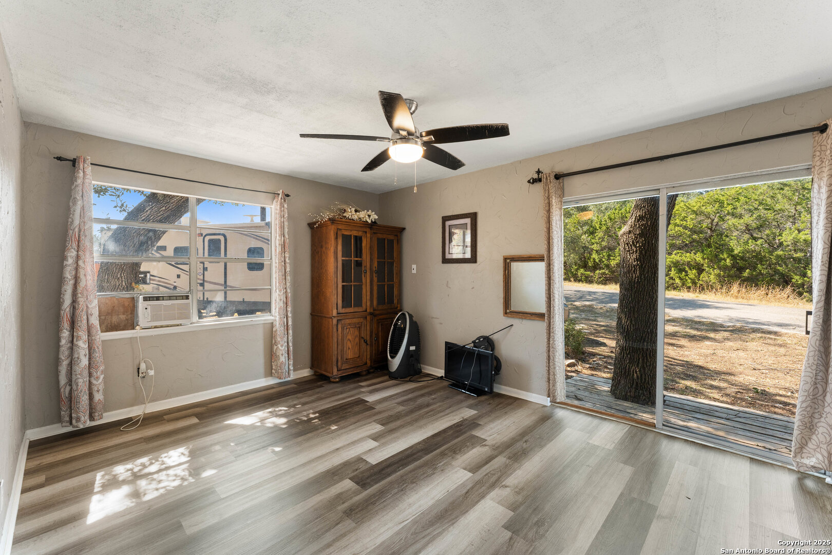 1843 Rhinestone Canyon Lake, TX 78133 - Photo 15 of 39 a view of livingroom with furniture wooden floor and a window