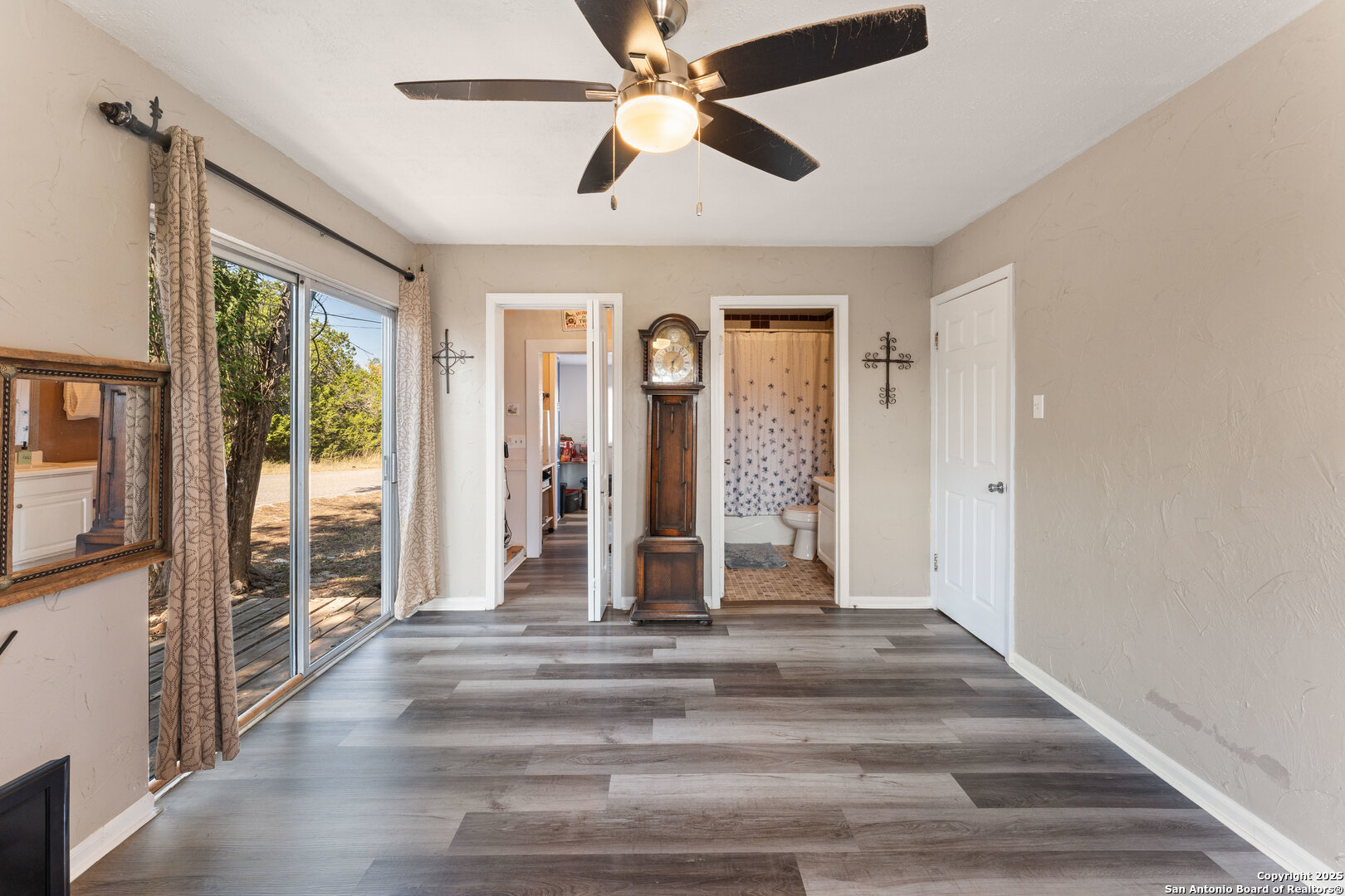 1843 Rhinestone Canyon Lake, TX 78133 - Photo 16 of 39 a view of a hallway with wooden floor and a ceiling fan