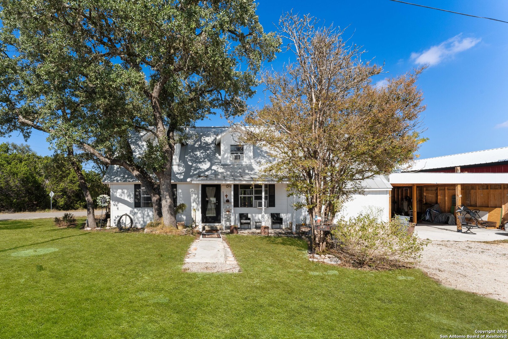 1843 Rhinestone Canyon Lake, TX 78133 - Photo 2 of 39 a front view of a building with a garden