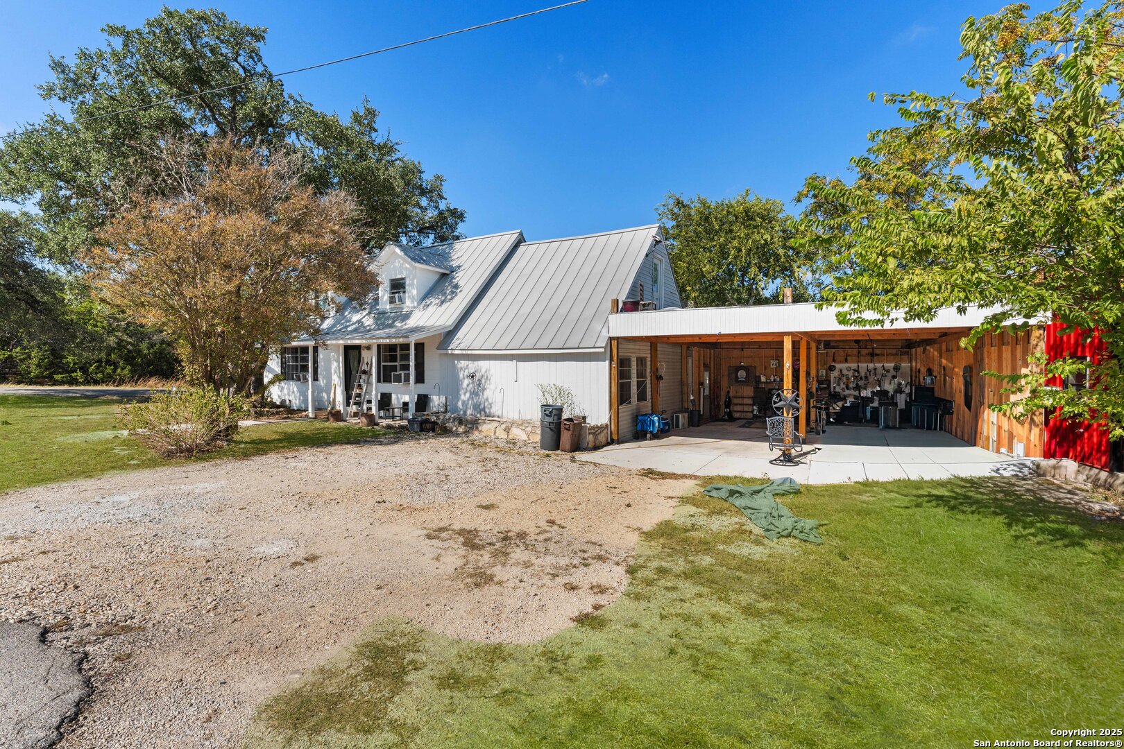 1843 Rhinestone Canyon Lake, TX 78133 - Photo 3 of 39 a front view of a house with a yard and garage