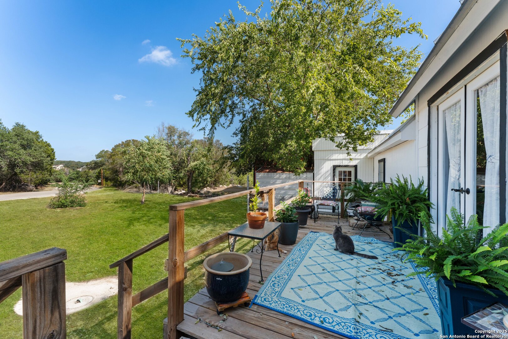 1843 Rhinestone Canyon Lake, TX 78133 - Photo 32 of 39 a view of a patio with table and chairs potted plants with wooden floor and fence