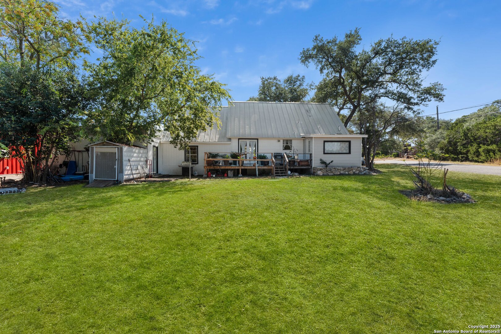 1843 Rhinestone Canyon Lake, TX 78133 - Photo 33 of 39 a view of a house with a big yard and large tree