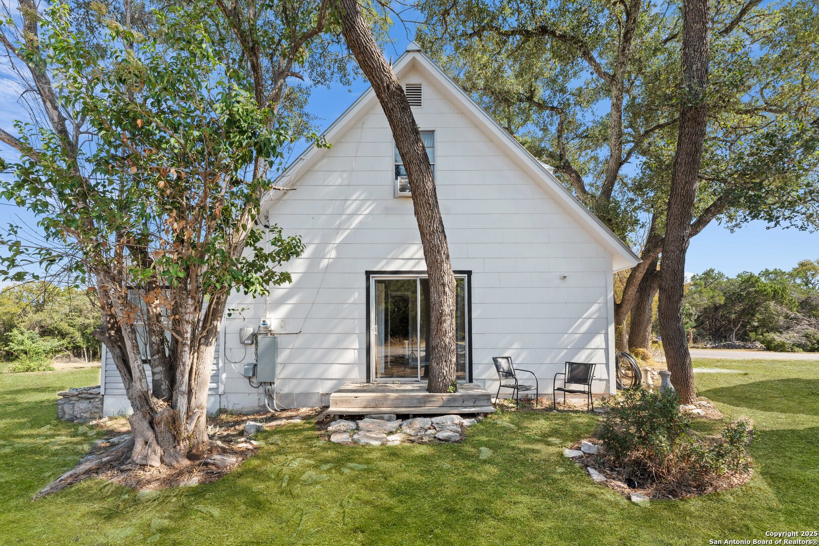 1843 Rhinestone Canyon Lake, TX 78133 - Photo 35 of 39 a view of a house with backyard and a tree