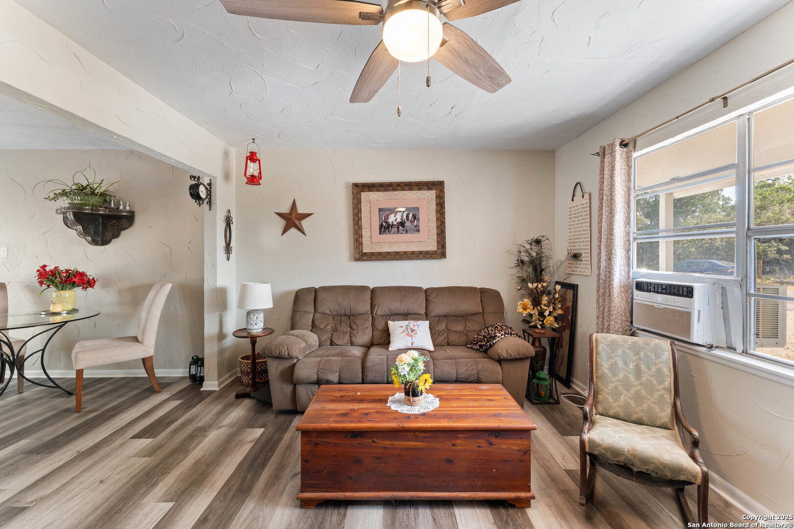 1843 Rhinestone Canyon Lake, TX 78133 - Photo 6 of 39 a living room with furniture a rug and a chandelier