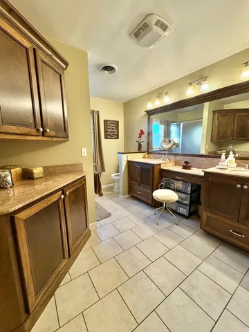 a kitchen with stainless steel appliances granite countertop a sink and cabinets