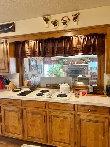 a kitchen with a stove and a white cabinets