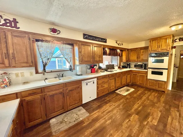 a kitchen with stainless steel appliances wooden cabinets a sink and a stove