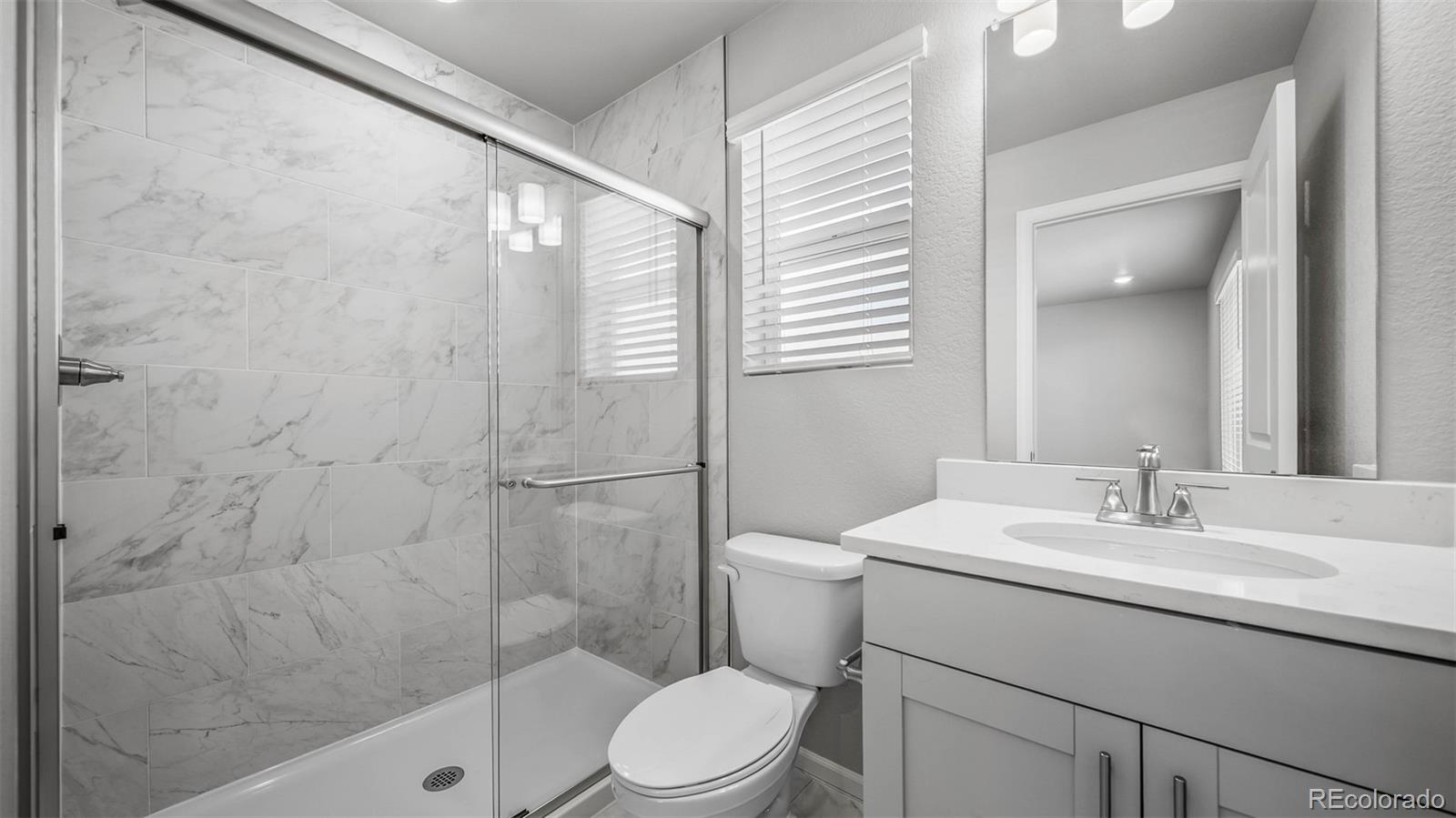 3970 North Rome Street Aurora, CO 80019 - Photo 15 of 22 a bathroom with a sink toilet and shower
