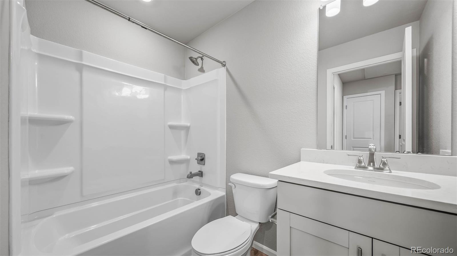 3970 North Rome Street Aurora, CO 80019 - Photo 19 of 22 a bathroom with a sink toilet and shower