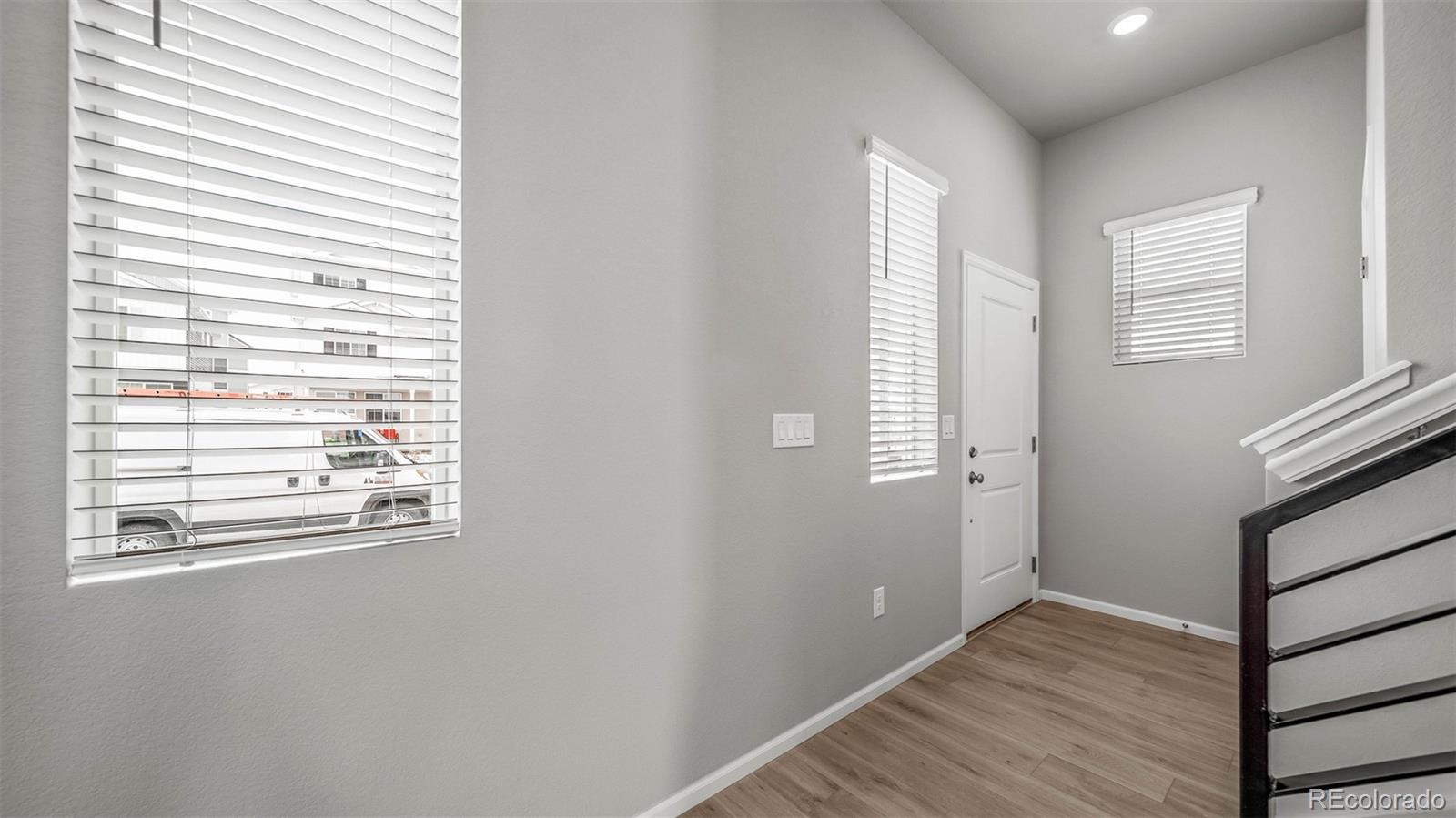3970 North Rome Street Aurora, CO 80019 - Photo 4 of 22 a view of an empty room with wooden floor and a window