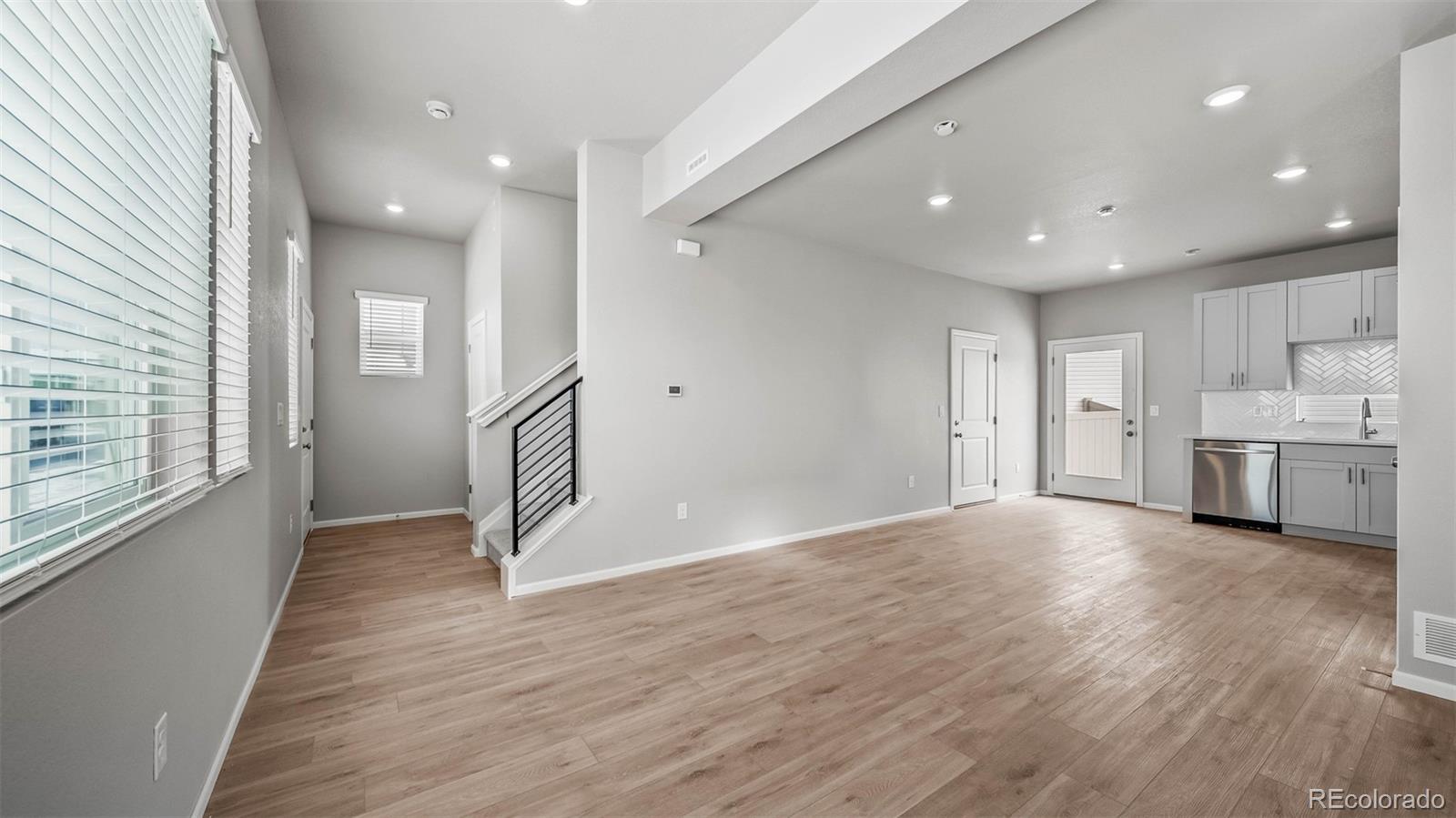 3970 North Rome Street Aurora, CO 80019 - Photo 5 of 22 a view of an empty room with wooden floor and a window