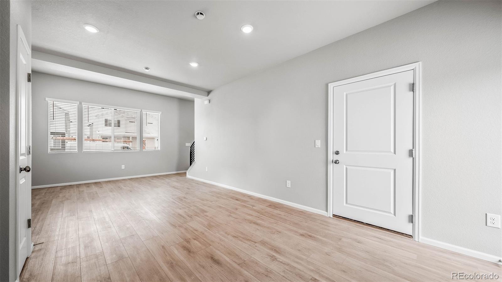 3970 North Rome Street Aurora, CO 80019 - Photo 8 of 22 wooden floor in an empty room with a window