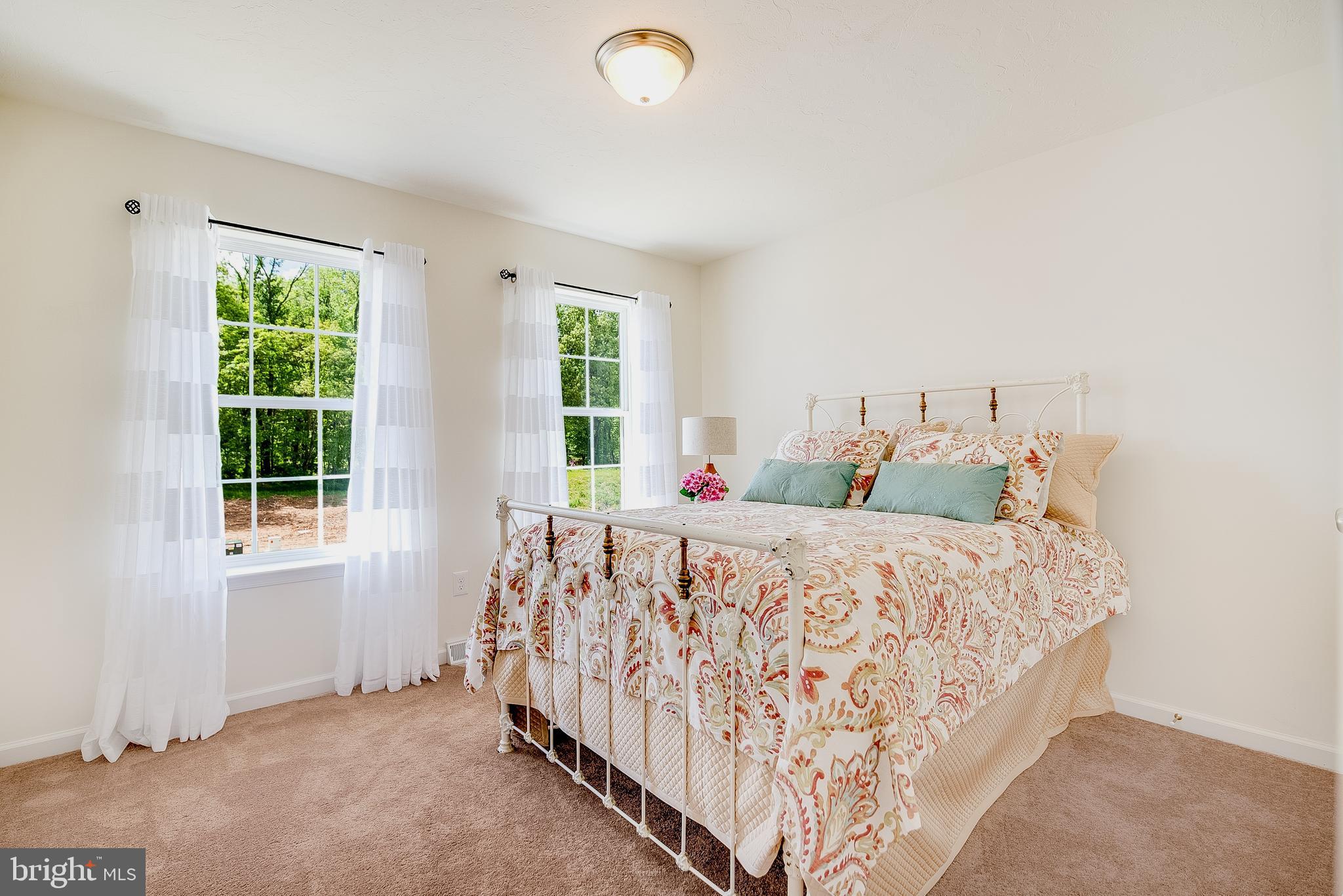 102 Piedmont Way, Unit 139 Hanover, PA 17331 - Photo 21 of 27 a bed sitting in a bedroom next to a window