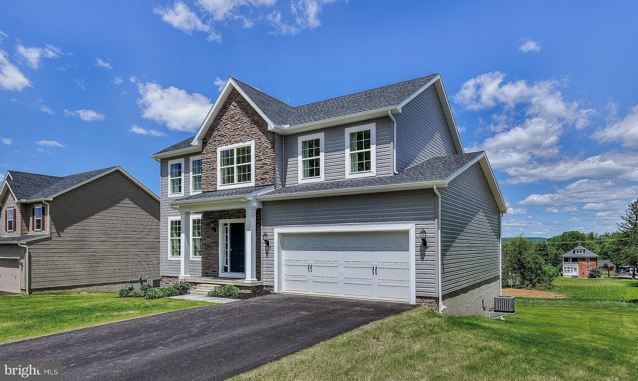 102 Piedmont Way, Unit 139 Hanover, PA 17331 - Photo 3 of 27 a front view of a house with a garden and yard