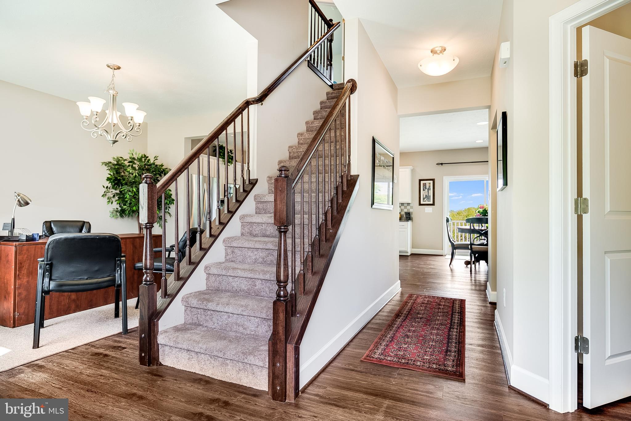 102 Piedmont Way, Unit 139 Hanover, PA 17331 - Photo 5 of 27 a view of a hallway with wooden floor and staircase