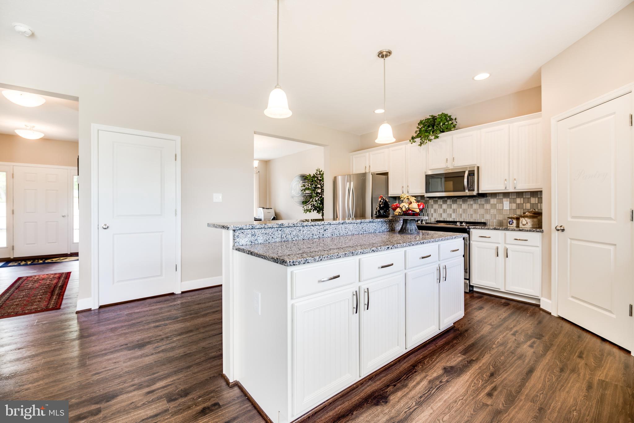 102 Piedmont Way, Unit 139 Hanover, PA 17331 - Photo 8 of 27 a kitchen with granite countertop white cabinets and white appliances