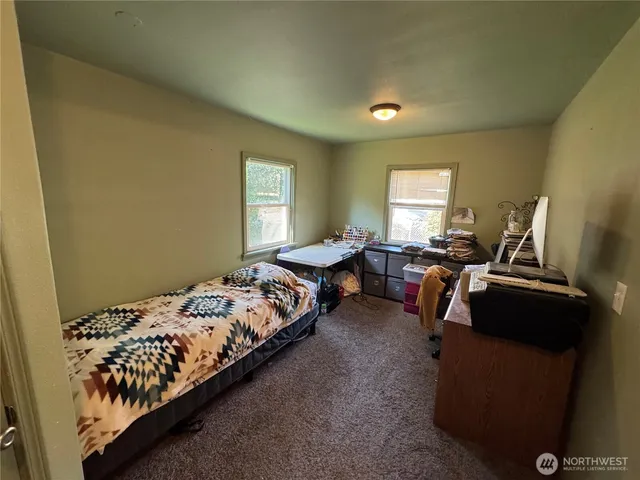 a bedroom with bed and a window