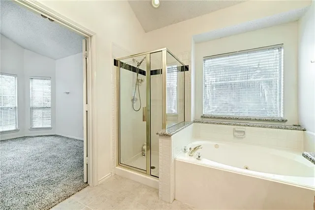 a bathroom with a bathtub and a shower