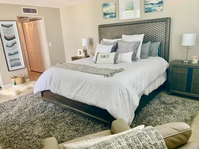 a living room filled with furniture and a floor to ceiling window