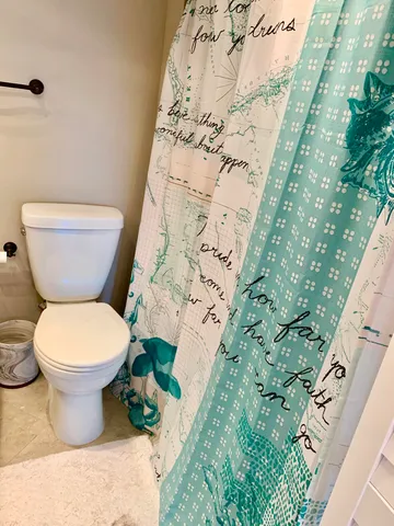 a view of multiple houses with a yard and palm trees