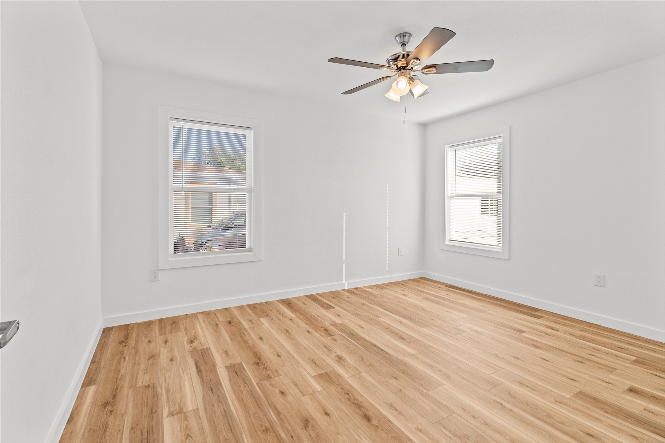 1715 West 4th Street Freeport, TX 77541 - Photo 4 of 9 a view of an empty room with a window and a chandelier fan