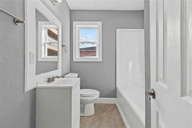 a bathroom with a sink toilet and vanity