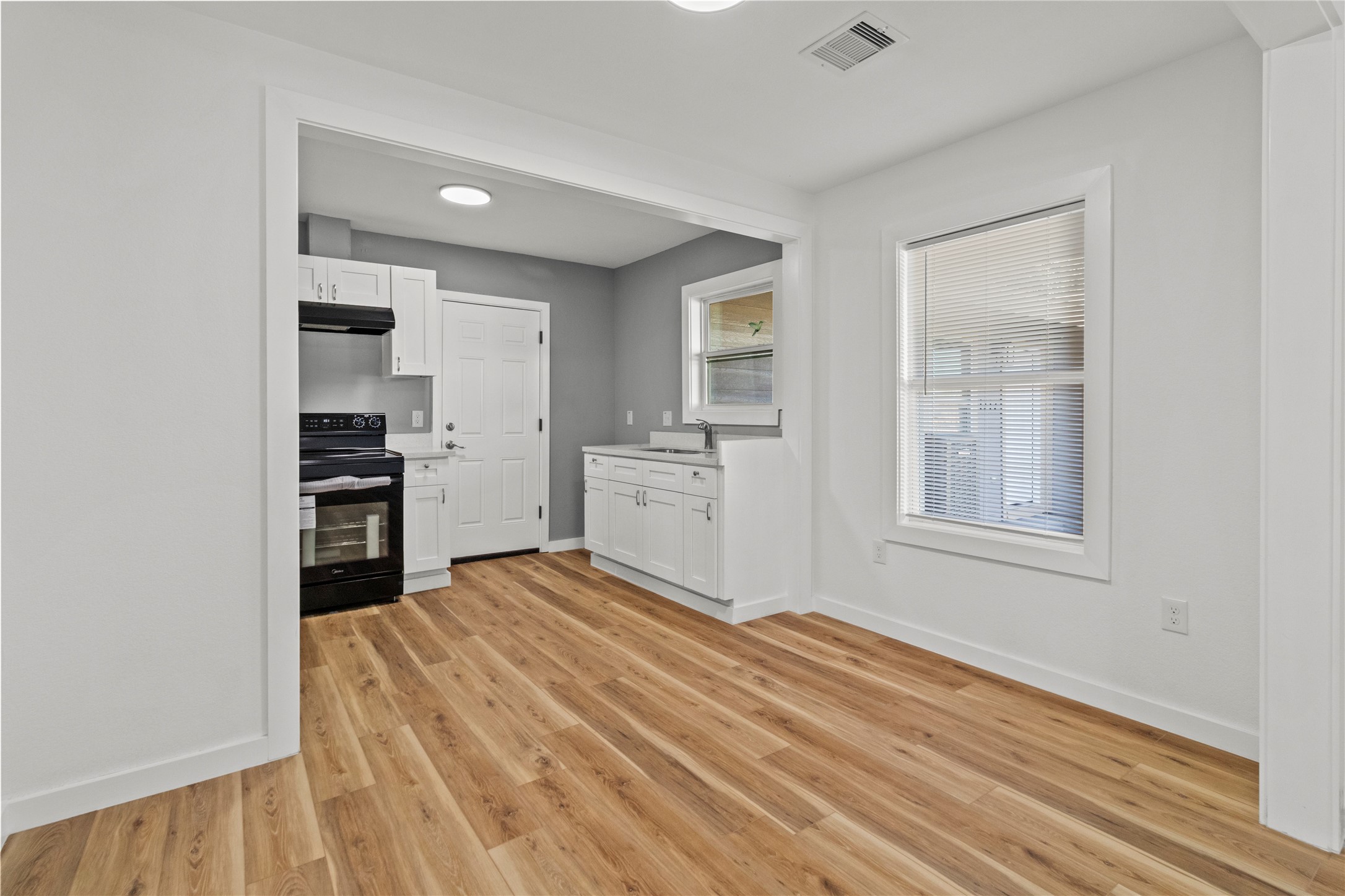1715 West 4th Street Freeport, TX 77541 - Photo 7 of 9 a view of a kitchen with wooden floor and a kitchen