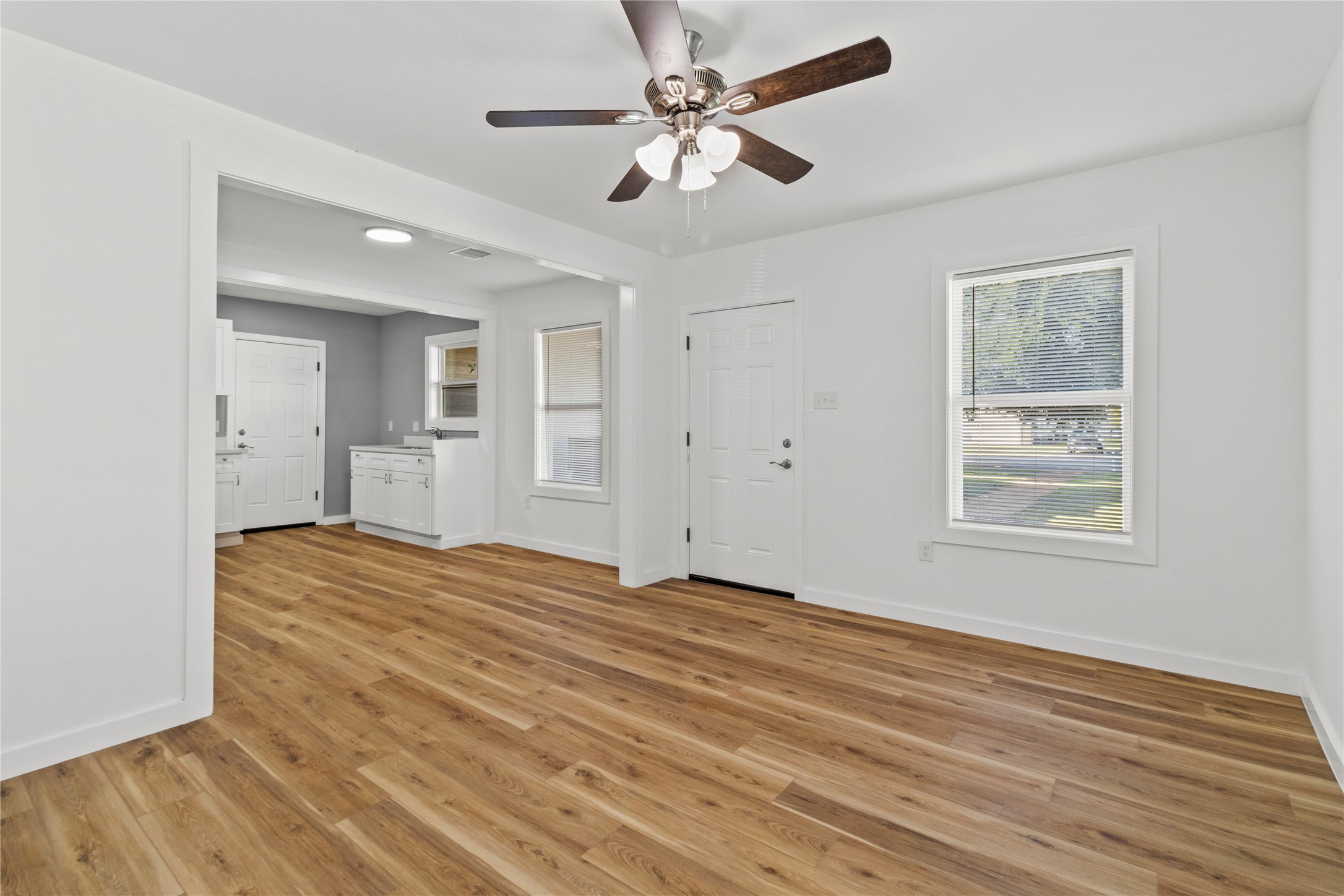 1715 West 4th Street Freeport, TX 77541 - Photo 8 of 9 a view of empty room with wooden floor and fan