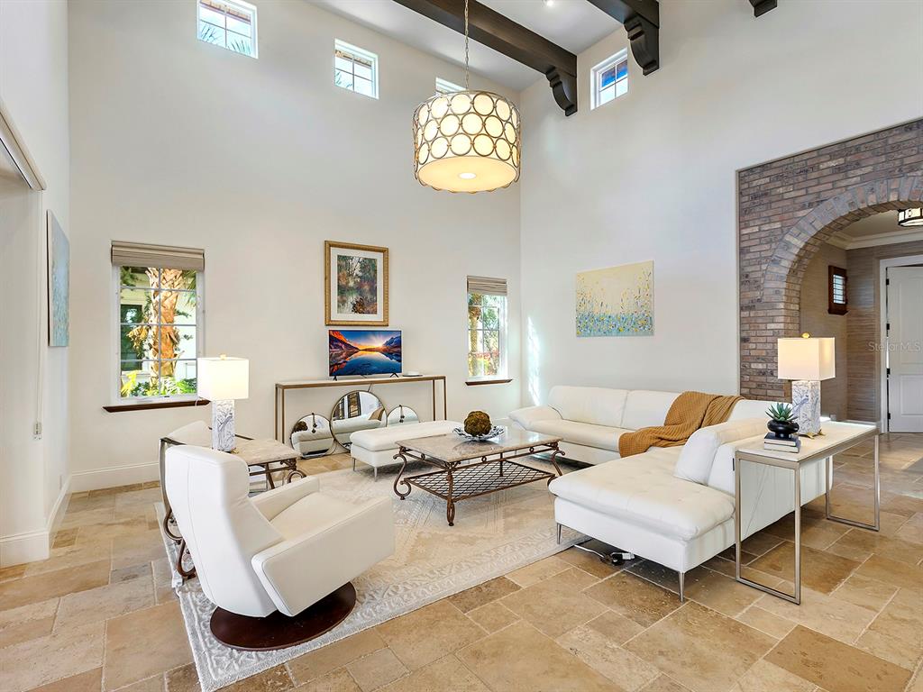 7951 Matera Court Lakewood Ranch, FL 34202 - Photo 13 of 81 a living room with furniture a chandelier and a window