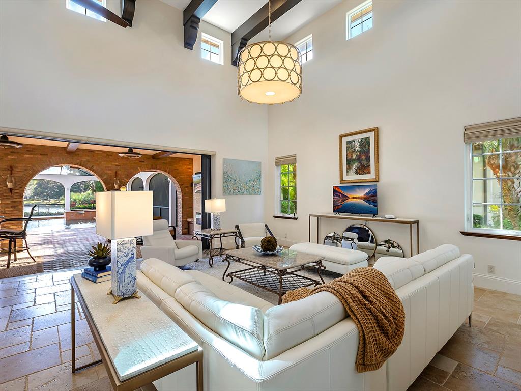 7951 Matera Court Lakewood Ranch, FL 34202 - Photo 17 of 81 a living room with fireplace furniture and a large window