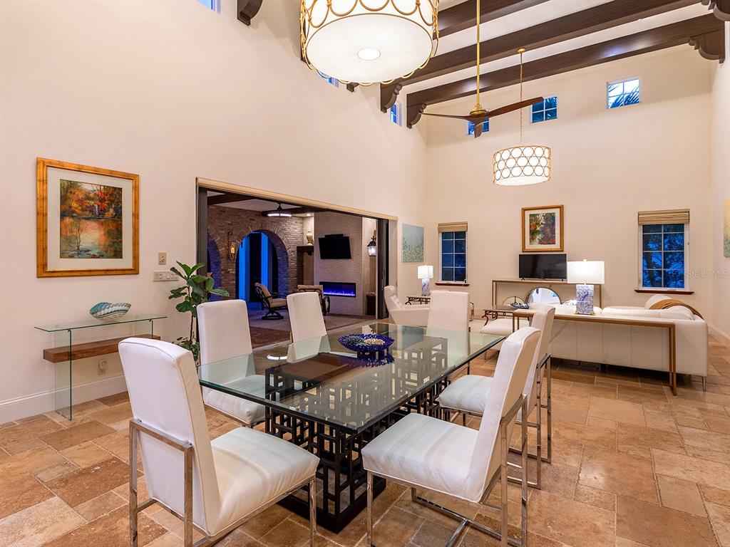 7951 Matera Court Lakewood Ranch, FL 34202 - Photo 18 of 81 a living room with furniture and a flat screen tv