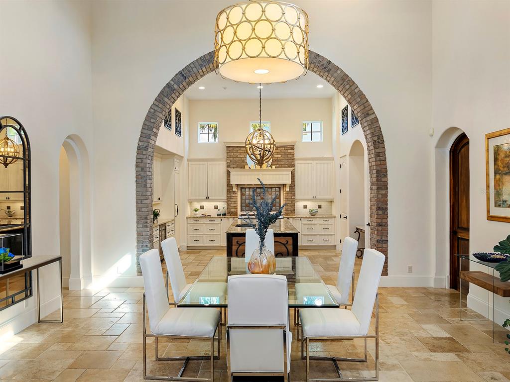 7951 Matera Court Lakewood Ranch, FL 34202 - Photo 22 of 81 a dining room with furniture a chandelier and wooden floor