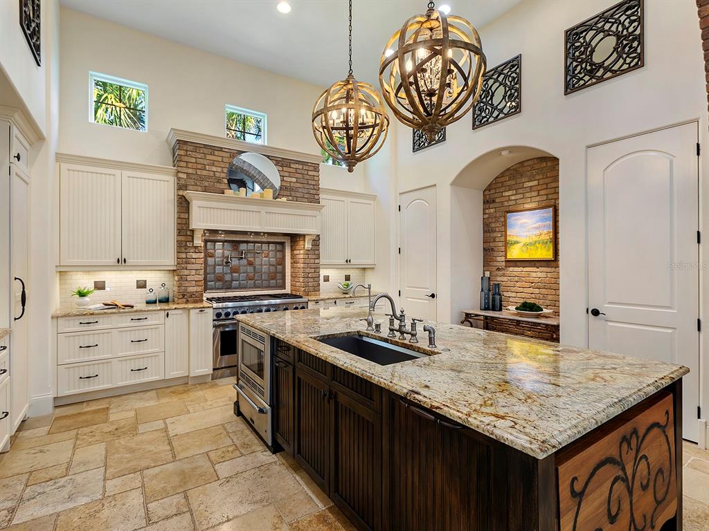 7951 Matera Court Lakewood Ranch, FL 34202 - Photo 27 of 81 a kitchen with stainless steel appliances granite countertop a stove a sink and a granite counter tops