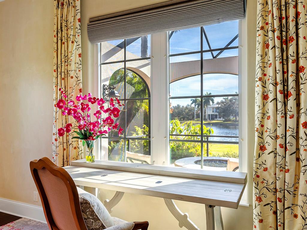 7951 Matera Court Lakewood Ranch, FL 34202 - Photo 30 of 81 a view of a dining room with furniture a chandelier and a large window