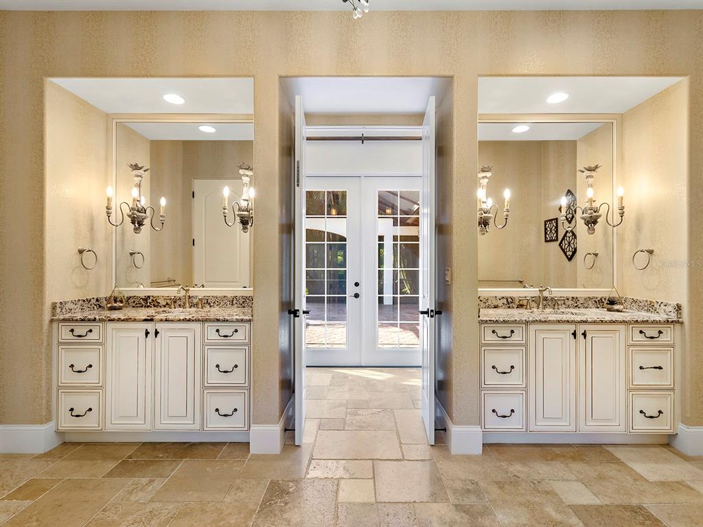 7951 Matera Court Lakewood Ranch, FL 34202 - Photo 31 of 81 a bathroom with a granite countertop sink mirror and shower