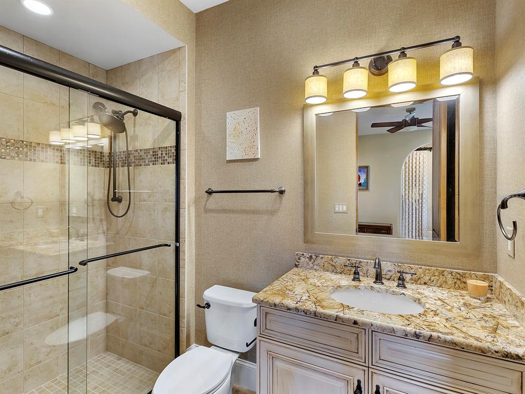 7951 Matera Court Lakewood Ranch, FL 34202 - Photo 39 of 81 a bathroom with a granite countertop sink toilet and shower