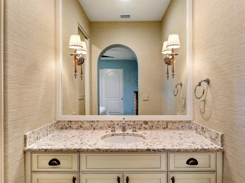 7951 Matera Court Lakewood Ranch, FL 34202 - Photo 42 of 81 a bathroom with a granite countertop sink and a mirror