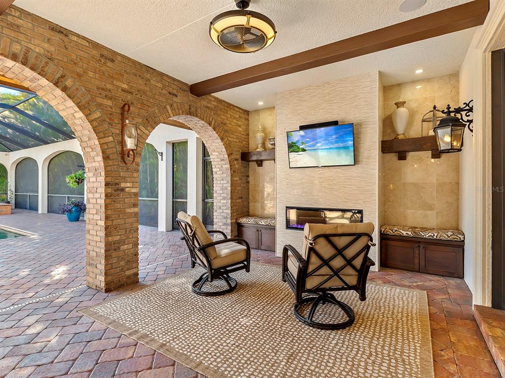 7951 Matera Court Lakewood Ranch, FL 34202 - Photo 46 of 81 a view of livingroom with furniture and a fireplace