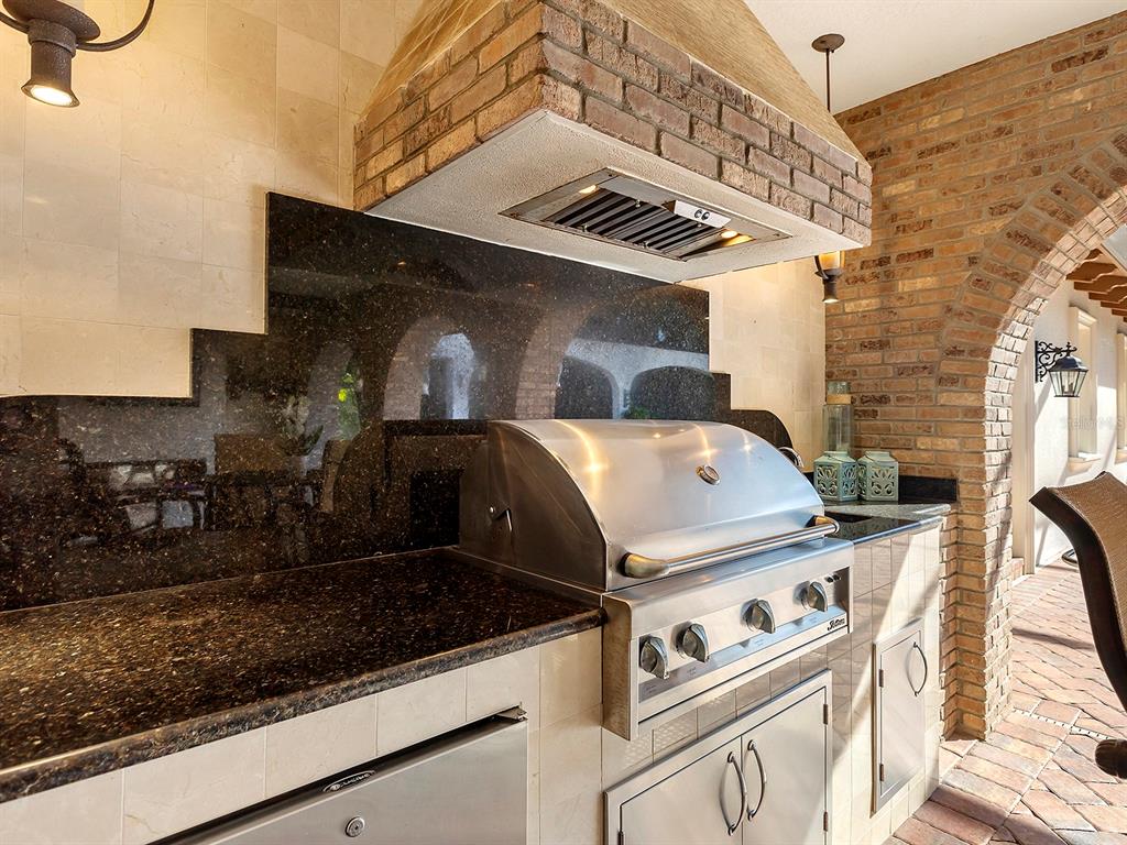 7951 Matera Court Lakewood Ranch, FL 34202 - Photo 48 of 81 a close view of a stove top oven and cabinets