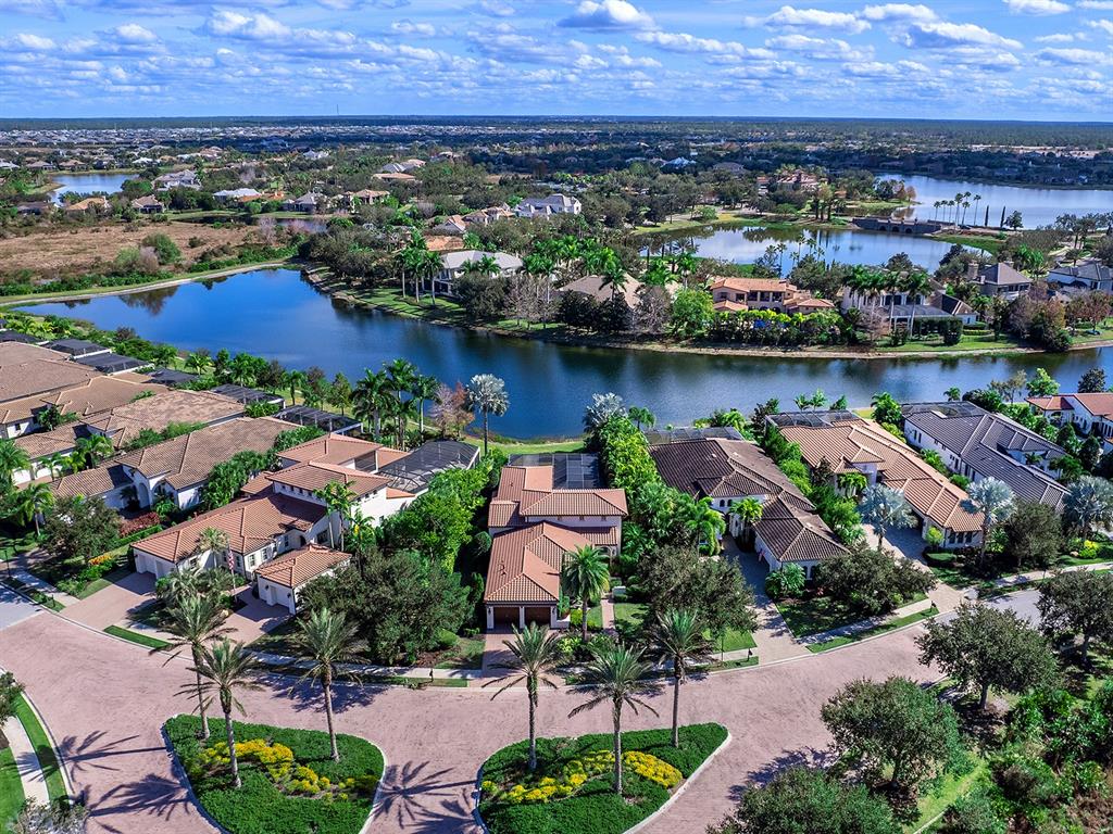 7951 Matera Court Lakewood Ranch, FL 34202 - Photo 63 of 81 an aerial view of residential houses with outdoor space and lake view