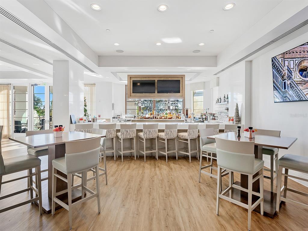 7951 Matera Court Lakewood Ranch, FL 34202 - Photo 73 of 81 a view of a dining room with furniture window and wooden floor