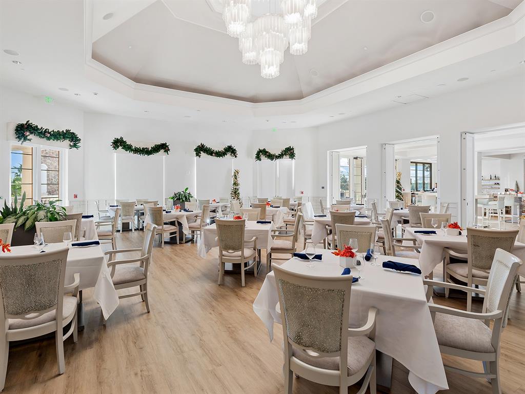 7951 Matera Court Lakewood Ranch, FL 34202 - Photo 74 of 81 a living room with lots of furniture and a chandelier
