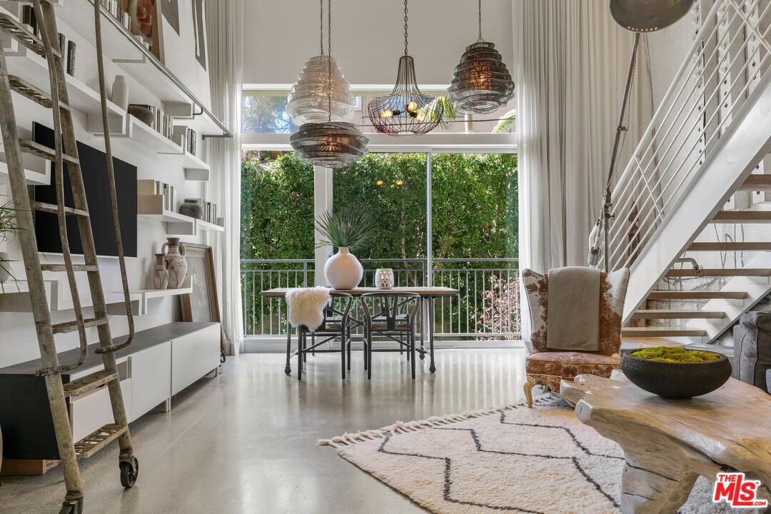 123 North Kings Road, Unit 11 Los Angeles, CA 90048 - Photo 4 of 27 a living room with furniture and a floor to ceiling window