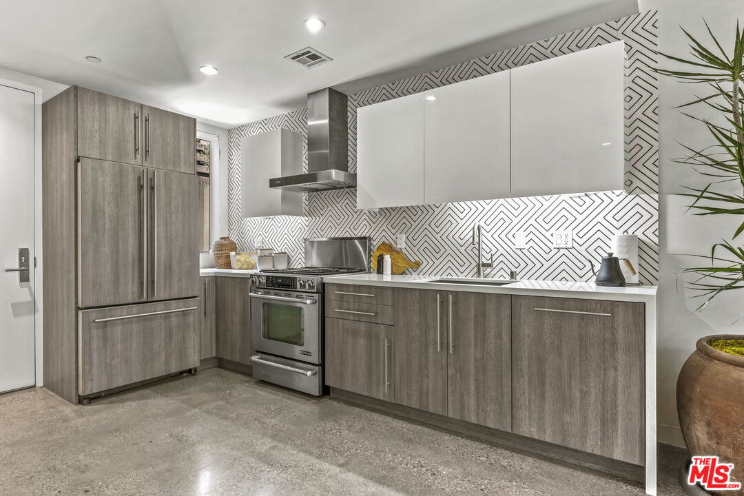 123 North Kings Road, Unit 11 Los Angeles, CA 90048 - Photo 8 of 27 a kitchen with stainless steel appliances granite countertop a refrigerator and a sink