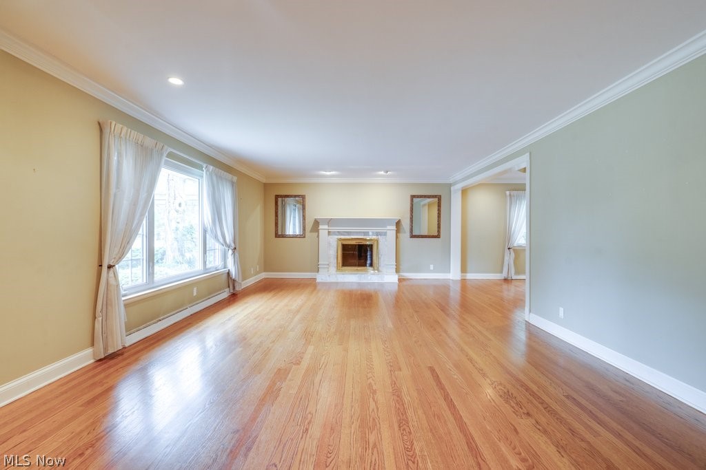 3060 Chamberlain Road Akron, OH 44333 - Photo 5 of 47 Unfurnished living room featuring ornamental molding and light wood-type flooring