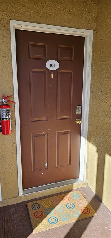 10167 Sailwinds Boulevard North, Unit 104 Largo, FL 33773 - Photo 2 of 3 a view of a door and bench in a room